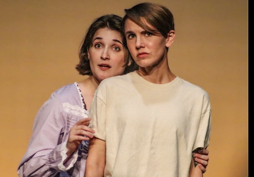 Two actors in a tender stage moment