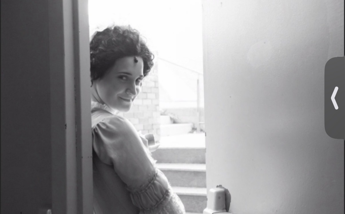 Black and white portrait in a sunlit doorway