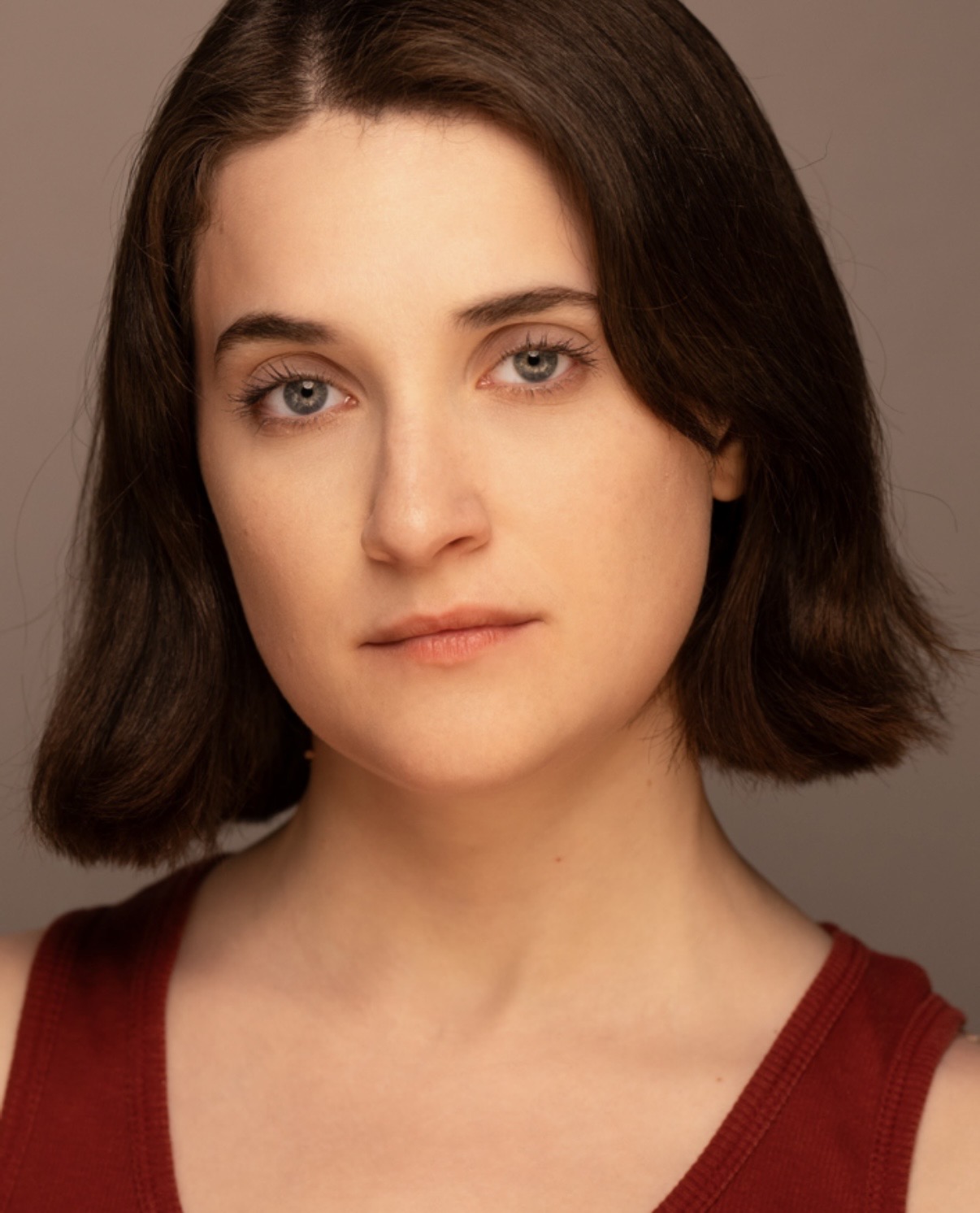Headshot — red tank, direct gaze